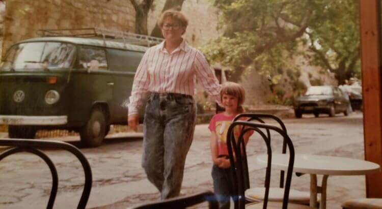 An old photo from the 1980's with a mom and her daughter walking in Greece.