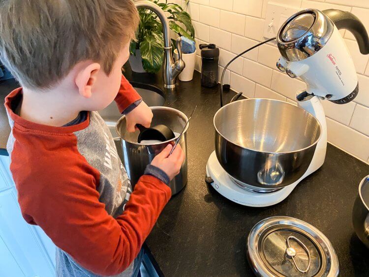 Making Greek cookies using a mixer in the kitchen with a little boy.