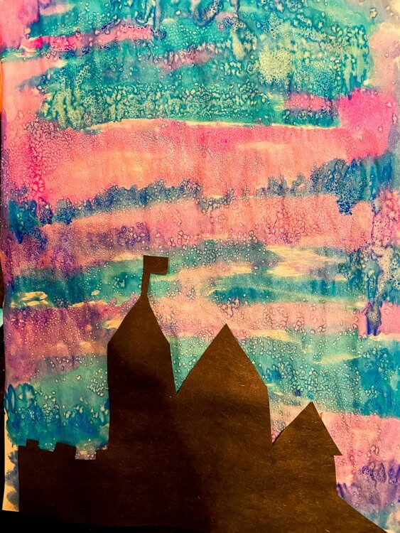 Watercolor painting with silhouette of a castle.