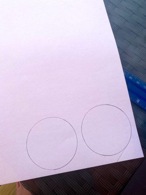 White circle shapes on white paper, ready to be cut.