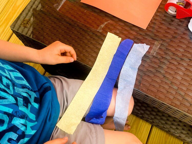 Laying the crepe paper on a layer of tape.