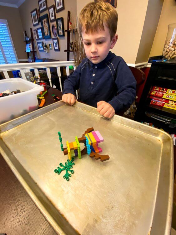 Showing the lego creation that has fallen down due to shaking the tray (earthquake).