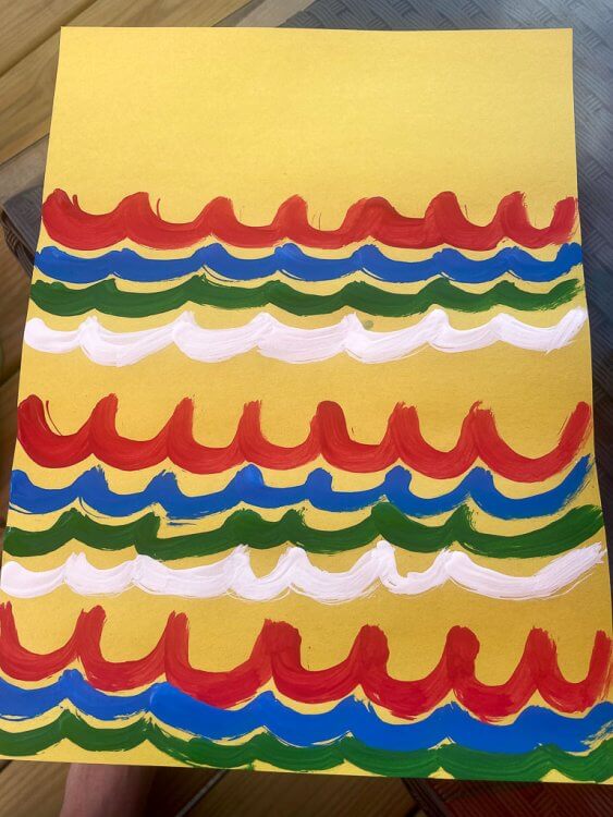 Wave colors on yellow construction paper for Japanese fish kites.